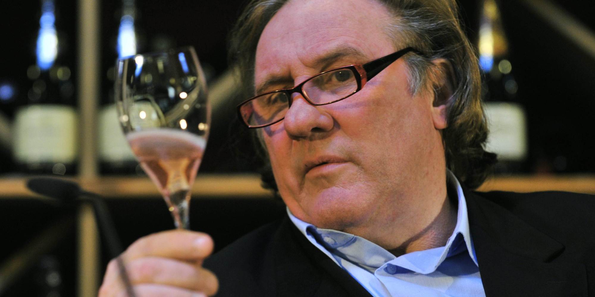 French actor Gerard Depardieu holds up a sample of his sparkling rose wine during a wine presentation in a Berlin wine shop November 30, 2010. Depardieu presented his "Taille Princesse" Brut, by Bouvet-Laduray, which the actor helped elaborate. AFP PHOTO / JOHN MACDOUGALL (Photo credit should read JOHN MACDOUGALL/AFP/Getty Images)